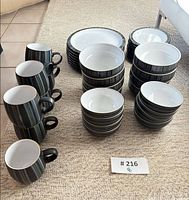 All 39 pieces grouped: mugs, plates, bowls