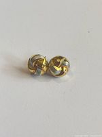 Pair of knot stud earrings on surface
