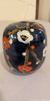 Front view of gosu blue Satsuma vase showing blossom design