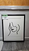 Front view of framed minimalist woman print with size tag