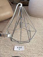 Full view of chrome geometric pendant with canopy and cord