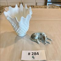 Fenton hobnail milk glass ruffled vase next to porcelain wolfhound figurine
