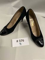 Full view of both Ferragamo heels side by side showing overall style