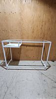 Front view of white metal frame table without glass top installed