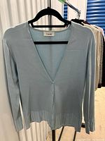 Front view of Laurèl blue cardigan on hanger