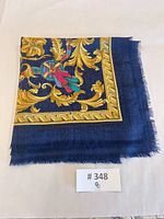 Textile folded showing border, fringe, and pattern