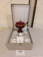 Open presentation case showing candy canister, Easter egg, satin lining
