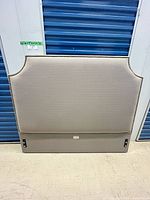 Front view of Pier 1 Imports queen headboard, showing fabric color and nailhead trim