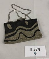 Front view of Pierre Cardin beaded evening bag showing wave motif and lot number card
