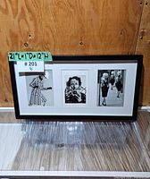 Full view of framed piece resting against wall