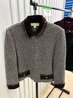 Front view of St. John tweed jacket showing velvet collar, pocket flaps, gold buttons