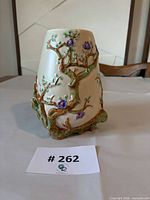 Front view of Clarice Cliff My Garden vase showing raised branch and flower detail, crazing/crack visible