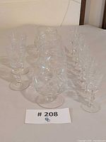 Full lot of 12 Bohemia pinwheel stemware pieces on table