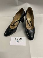 Pair of Bruno Magli black leather heels front angle