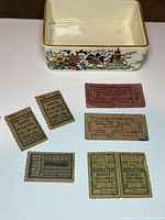 Group shot showing ceramic Sandland Ware box and all seven tickets