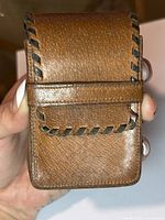 Front view of brown leather cigarette case with whipstitched edges