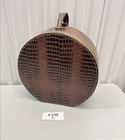 Front view showing reptile-embossed exterior and handle