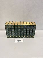 All ten green Reader’s Digest Condensed Books in a row spines facing, lot number card visible