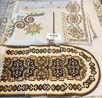 Assorted embroidered linens showing all seven pieces