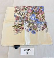 Scarf folded showing floral design and label tag