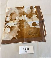 Folded Jean Patou scarf showing logo