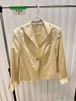 Front view of cream silk satin blazer on hanger