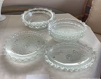 Group shot of all nine clear glass serving dishes on table