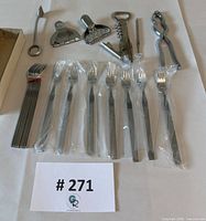 All items laid out showing forks in plastic sleeves, stacked forks, and six bar tools