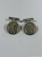 Front view of both cufflinks showing Viking longship design