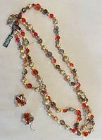 Full view of necklace with hang tag and both earrings