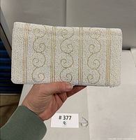 Front view of hand-beaded clutch showing swirl pattern