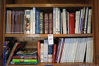 Full view of two shelves filled with assorted cookbooks