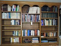 Full view of six-shelf bookcase filled with books