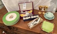 Overview showing plates, napkin rings, Chinese spoons, goblets, yellow dishes, square dish