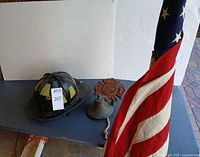 Group shot of helmet, bell, emblem, flag
