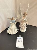 Front view of both Lladró angel figurines together