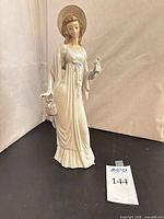 Full view of Lladro “Dainty Lady” porcelain figurine showing front details and scale tag
