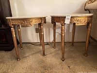 Both giltwood console tables side by side showing overall design