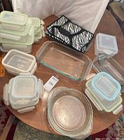 Overview of glass storage containers, baking dishes and carrier on table