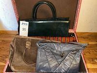 Front view showing four handbags in lot