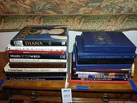 Two stacks of hardcover books on dresser