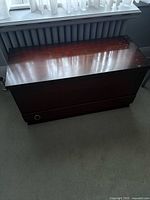 Oak blanket box closed, shows overall form, color, and drawer pull