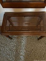 Rectangular oak stool showing cane seat damage, frame and legs visible