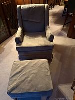 Front view of sage green armchair and ottoman showing design and fabric