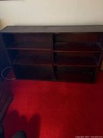 Front view of dark oak low bookcase showing six shelves