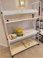 Front view of assembled grow rack showing four tiers, Floralight fixture, trays and accessories