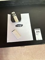 Apple TV unit with remotes and manual overview