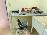 overview of pots, brackets, small hardware on table