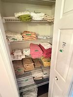 Closet shelves with assorted towels and linens