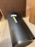 Full view of black Bazooka bass tube lying on floor